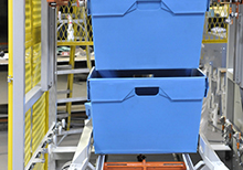 Stack of Totes Lifted to Dispense a Single Tote
