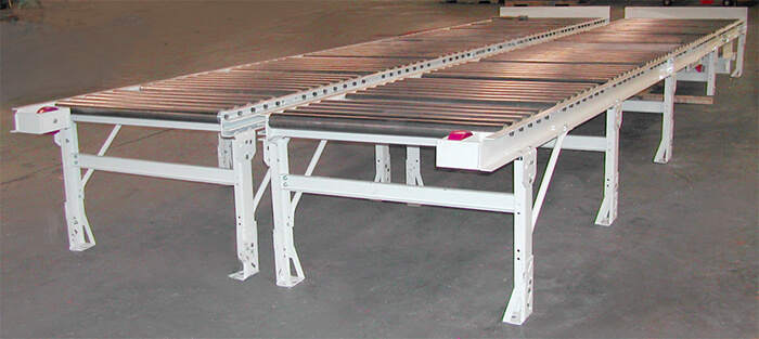 Extra-wide Gravity Conveyors with inertial brakes to convey large crates in a shipping area.