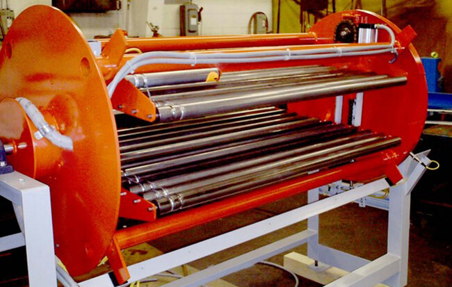 Roll-Over with live roller bed sections; used to orient product prior to auto palletizing.