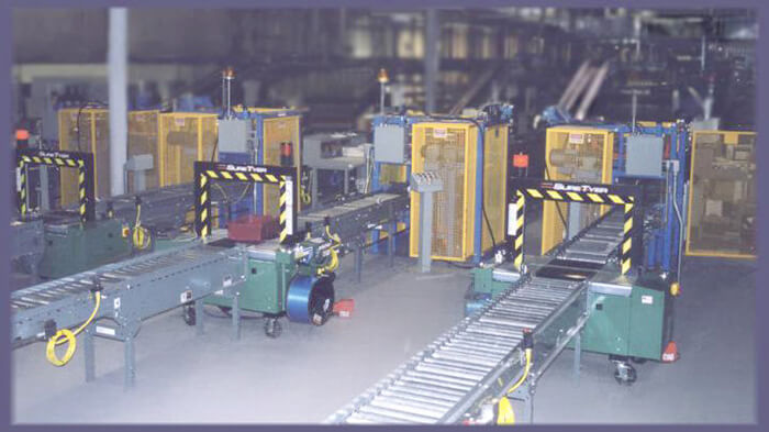 Multiple Lidding Machines installed in a distribution center. (Seen from the exit end).