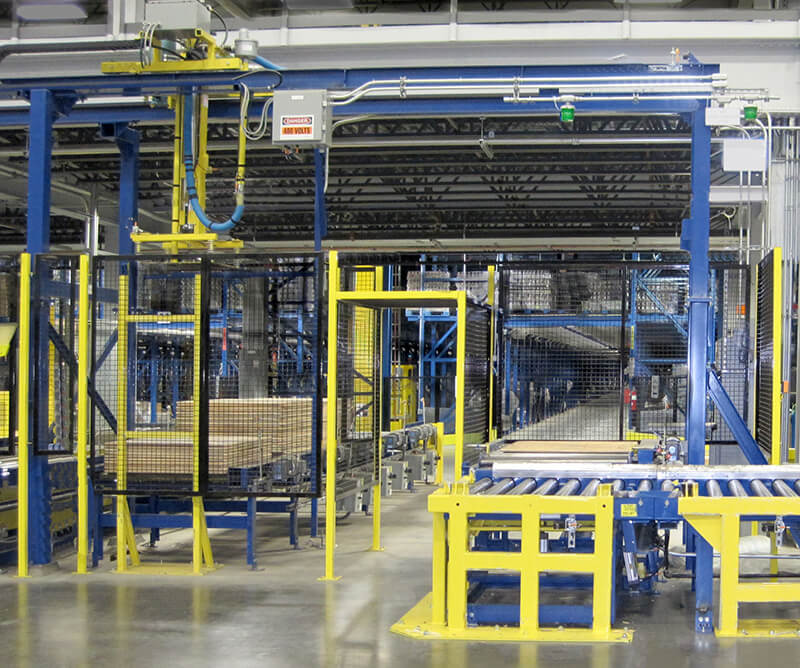 Slave pallet dispensing at an automated receiving cell in a dry goods distribution center.