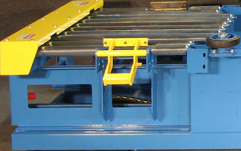 Heavy duty anti-back up stop used for locating pallets for automatic right-angle transfer.